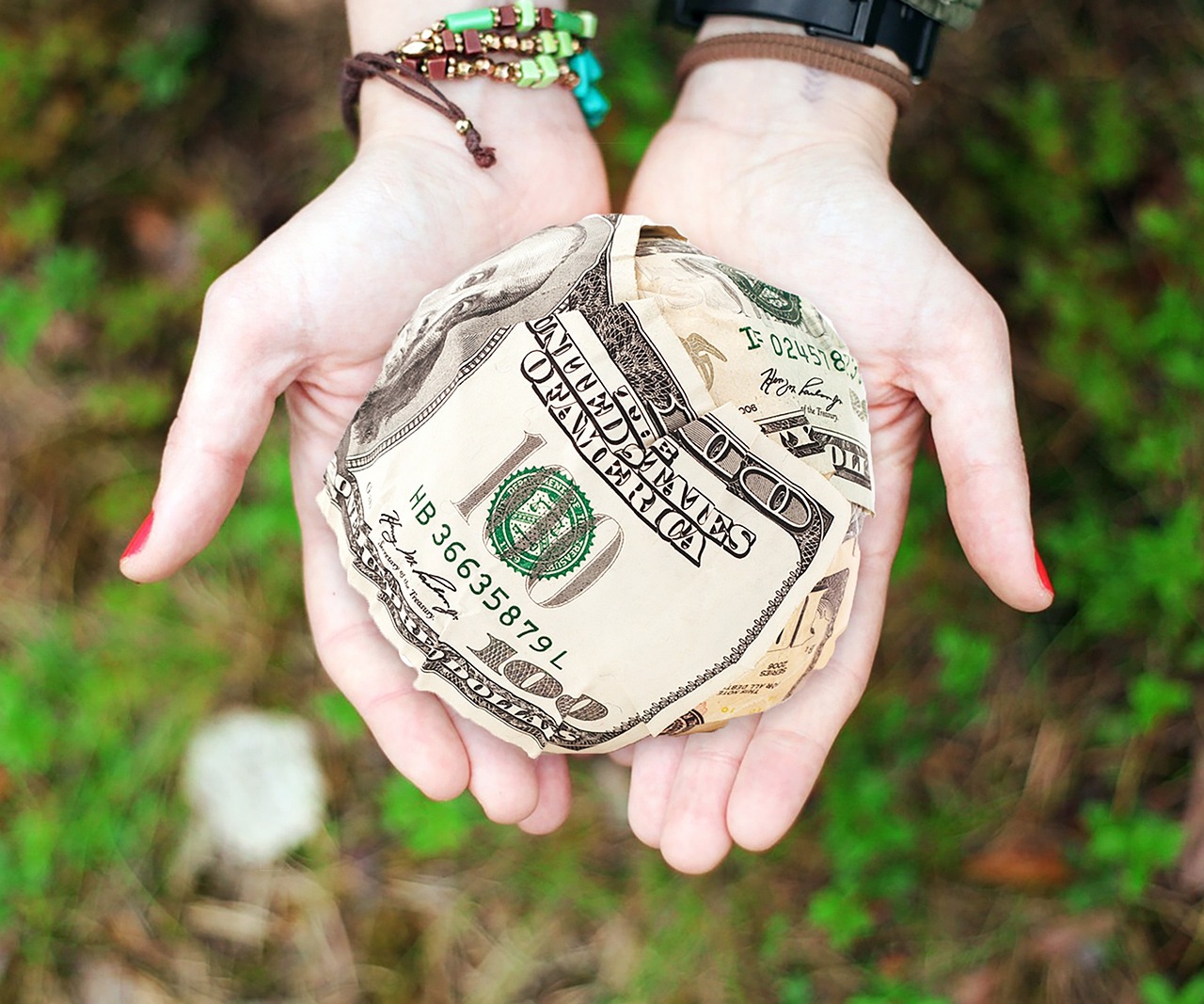 Hands offering charitable gift representing beneficiary giving