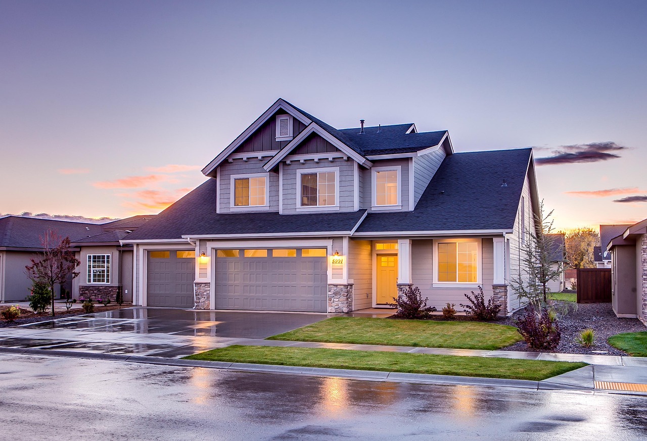 Beautiful residential home at dusk with warm interior lighting